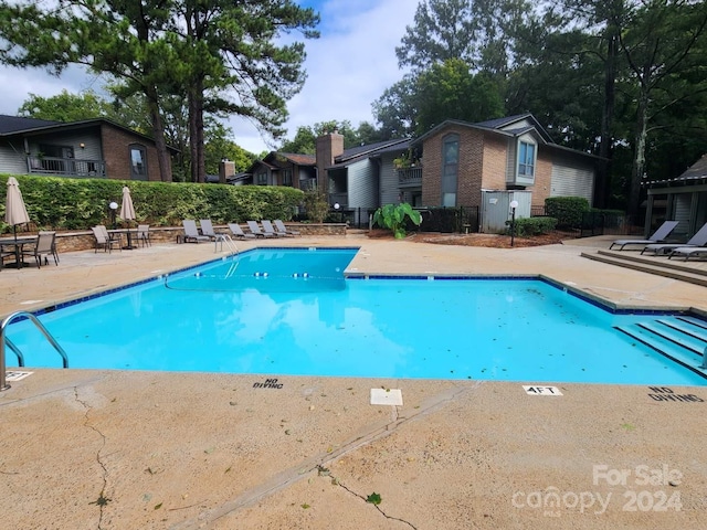 view of swimming pool with a patio