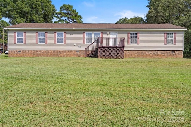 view of front of property featuring a front yard and a wooden deck