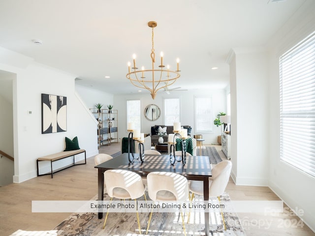 interior space featuring light wood-type flooring, a chandelier, and a healthy amount of sunlight