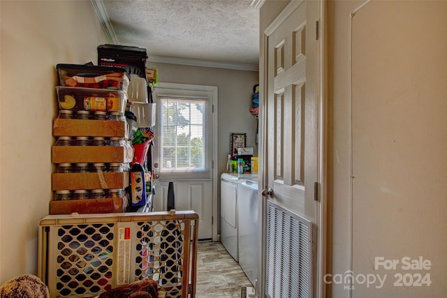 wine cellar featuring washer and dryer, ornamental molding, and a textured ceiling