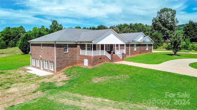 view of front facade featuring a sunroom and a front lawn