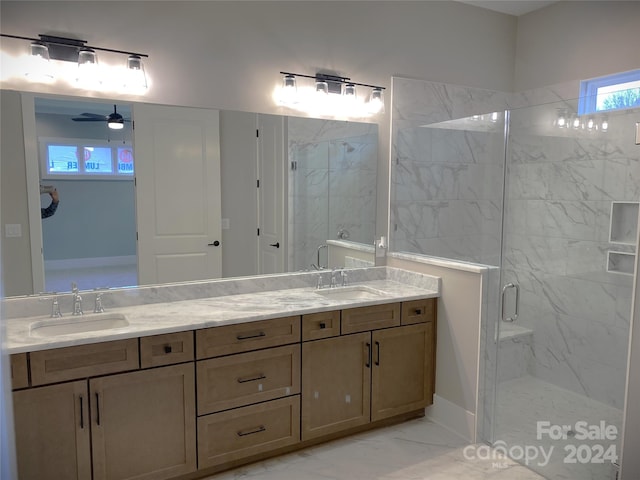 bathroom featuring ceiling fan, vanity, and a shower with shower door