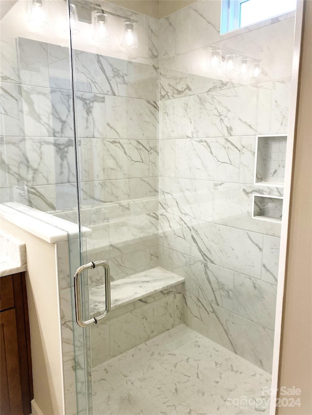 bathroom featuring vanity and a shower with shower door