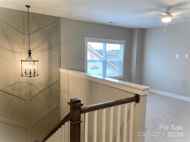 stairs with carpet flooring and ceiling fan