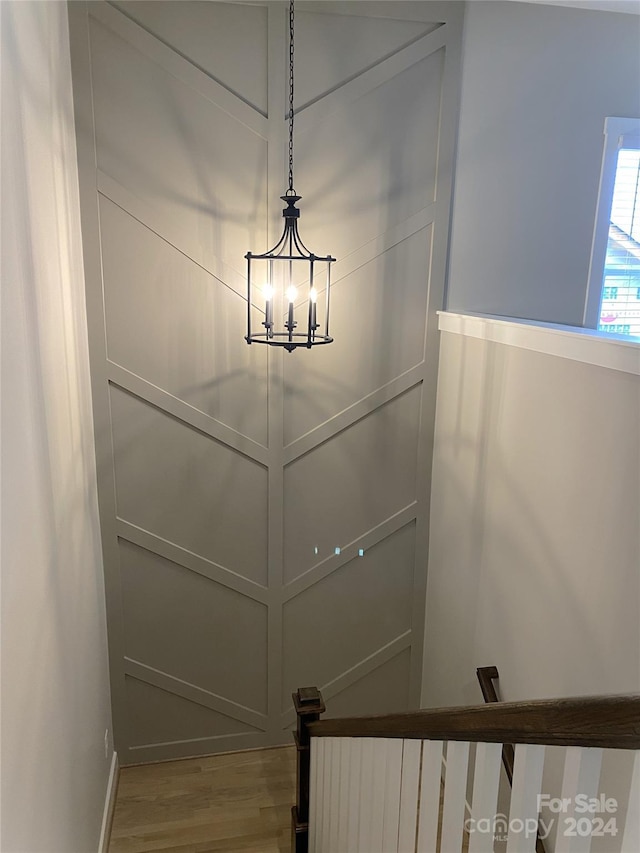 details featuring a notable chandelier and hardwood / wood-style flooring