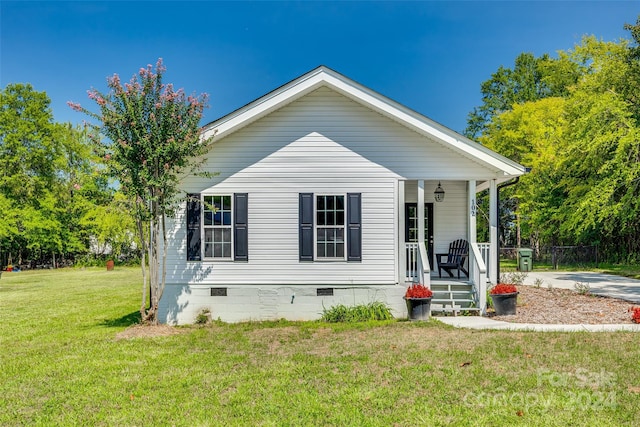 view of front of property with a front yard and covered porch