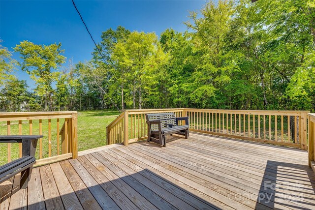 wooden terrace with a yard