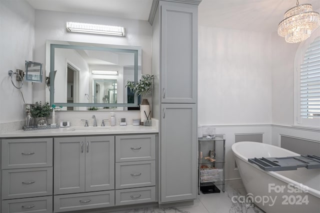 full bath featuring a chandelier, a soaking tub, wainscoting, and vanity