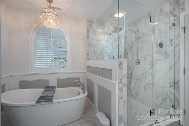 bathroom with separate shower and tub and a chandelier