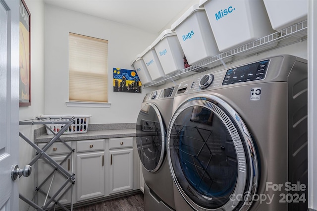 laundry room with washer and clothes dryer and dark wood-type flooring