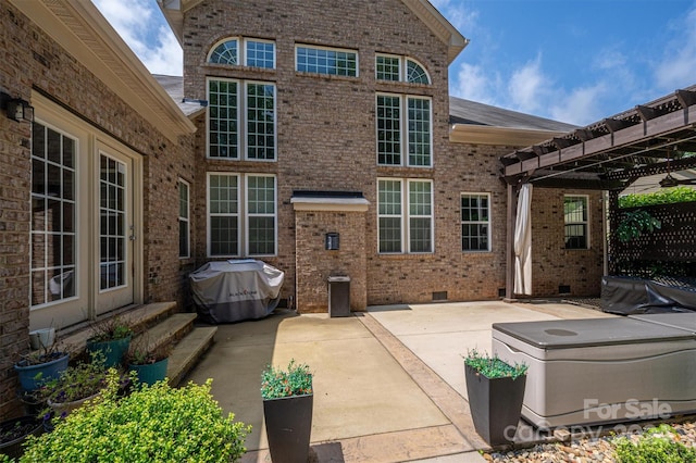 rear view of house with a pergola and a patio area