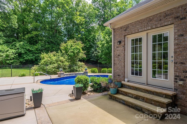 view of swimming pool featuring a patio area