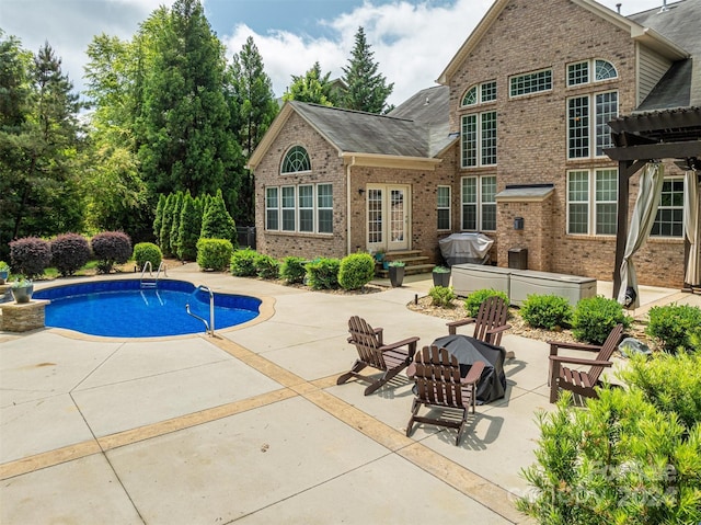 outdoor pool featuring a patio, entry steps, and a pergola