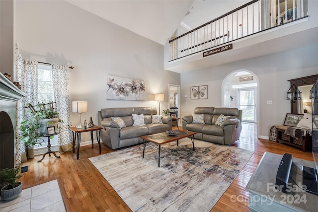 living room featuring hardwood / wood-style floors and high vaulted ceiling