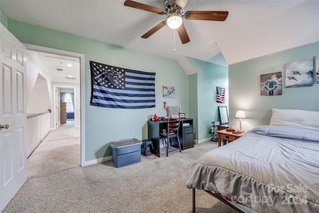 bedroom featuring a textured ceiling, carpet, and ceiling fan