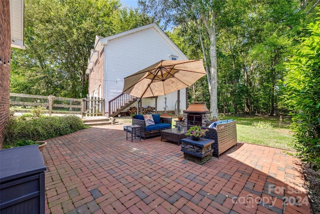 view of patio with an outdoor living space and a grill