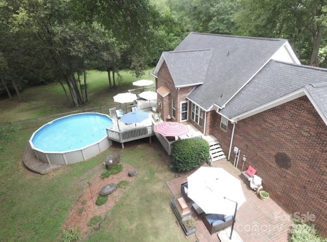 view of pool featuring a yard and a deck