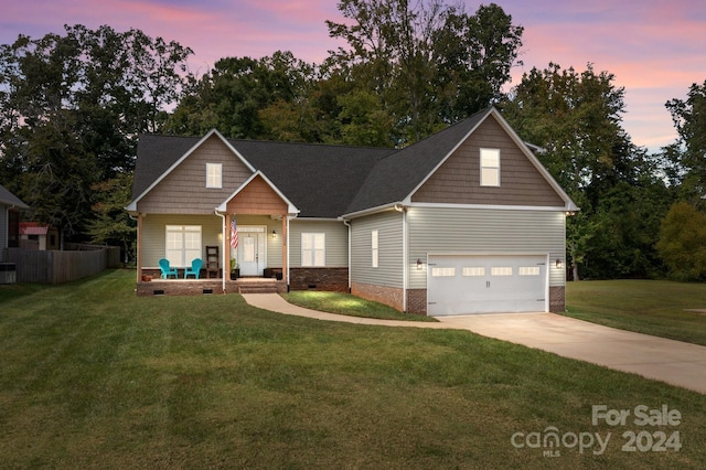 view of front facade with a yard and a garage