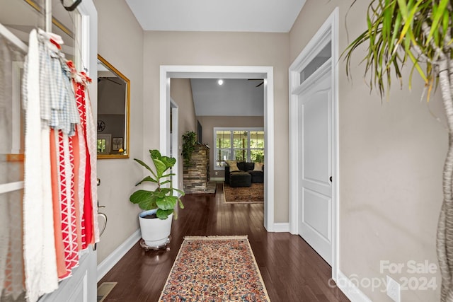 hallway with dark hardwood / wood-style flooring