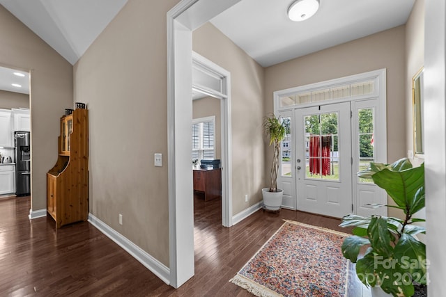 foyer featuring dark hardwood / wood-style floors and vaulted ceiling