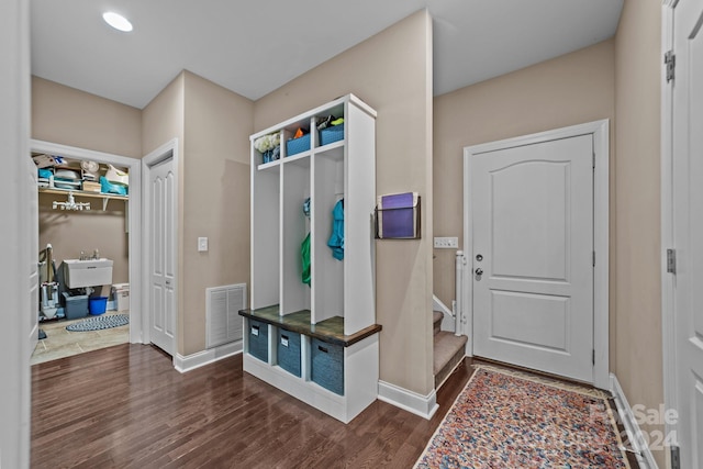 mudroom with sink and dark hardwood / wood-style floors