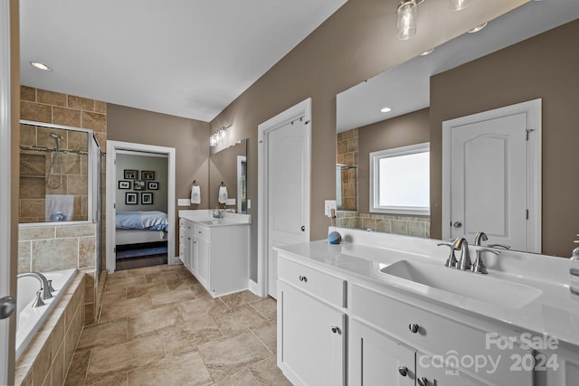 bathroom with vanity and independent shower and bath