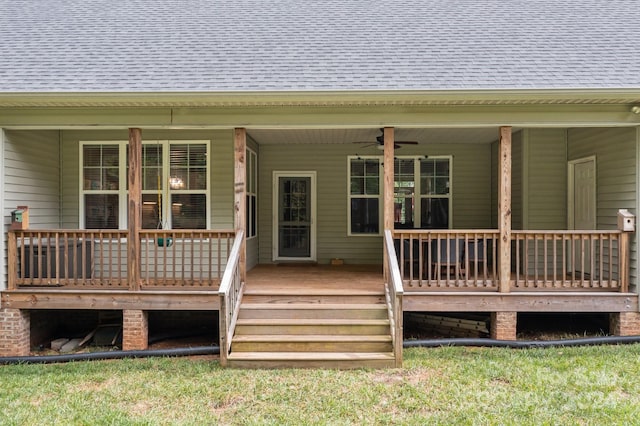 deck featuring a yard and ceiling fan