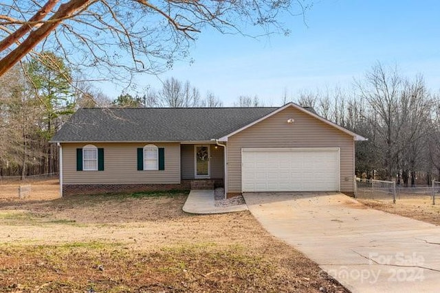 ranch-style home featuring a garage and a front yard