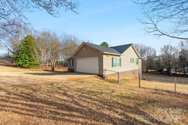 view of side of property with a yard and a garage