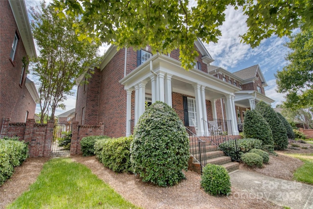 greek revival inspired property featuring covered porch