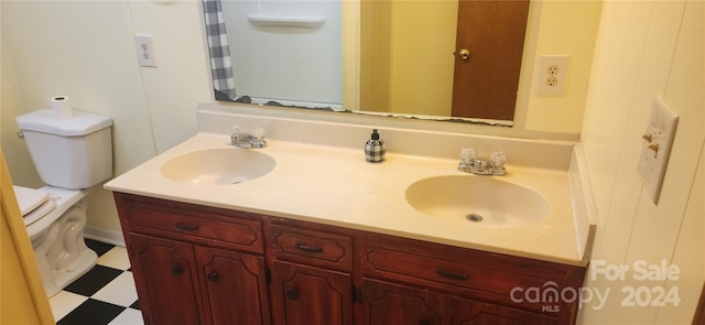 bathroom featuring toilet and vanity