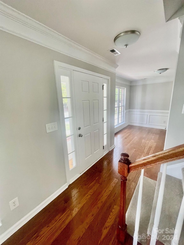 entryway featuring crown molding and dark wood-type flooring