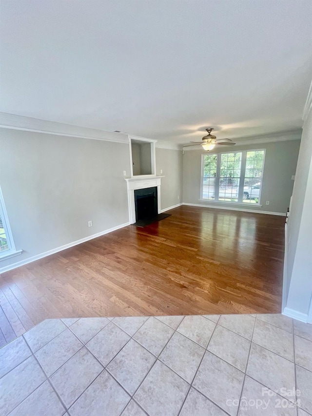 unfurnished living room featuring crown molding, light hardwood / wood-style flooring, and ceiling fan