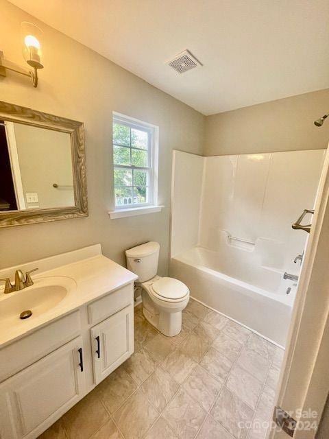 full bathroom with vanity, toilet, and  shower combination