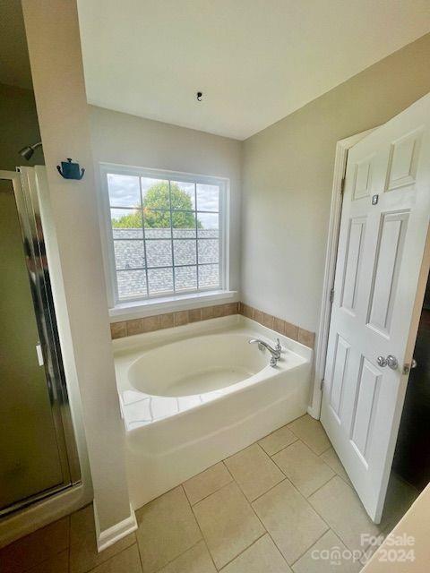 bathroom with plus walk in shower and tile patterned flooring