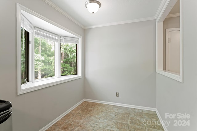 unfurnished room with ornamental molding and light tile patterned floors