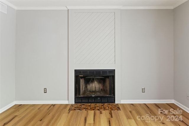 room details with hardwood / wood-style floors and crown molding