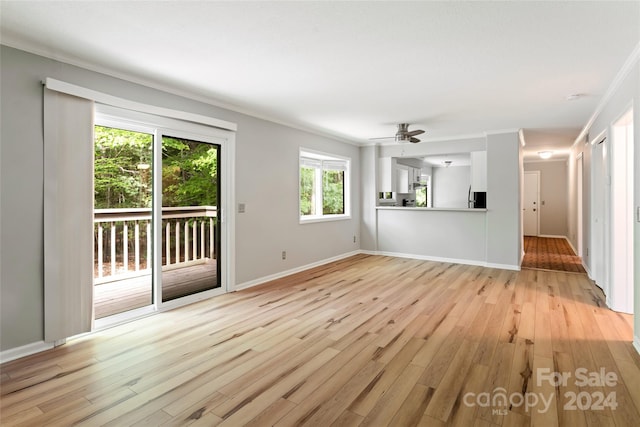 unfurnished living room with crown molding, ceiling fan, and light hardwood / wood-style floors