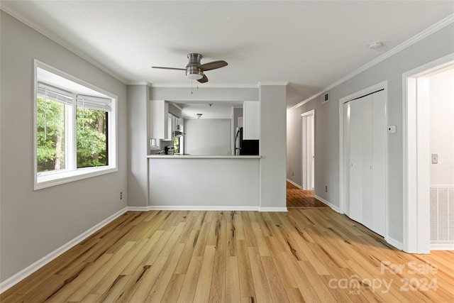 interior space with crown molding, light hardwood / wood-style flooring, and ceiling fan