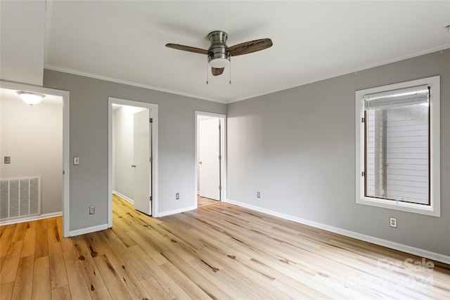 interior space featuring ceiling fan, ornamental molding, and light wood-type flooring