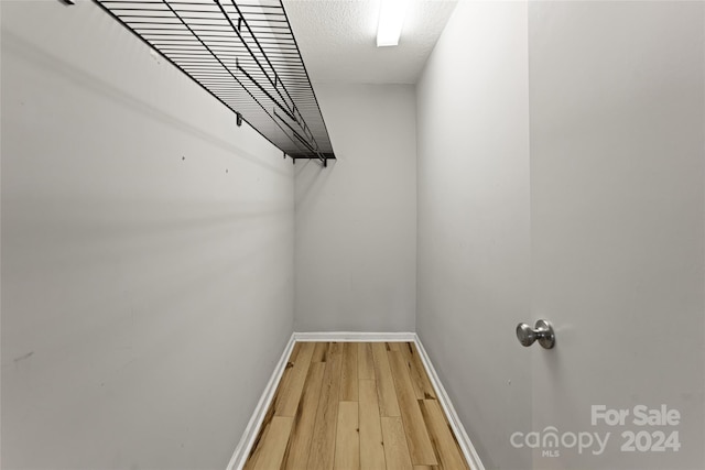 walk in closet featuring light hardwood / wood-style flooring