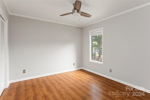 unfurnished bedroom featuring ornamental molding, hardwood / wood-style flooring, and ceiling fan