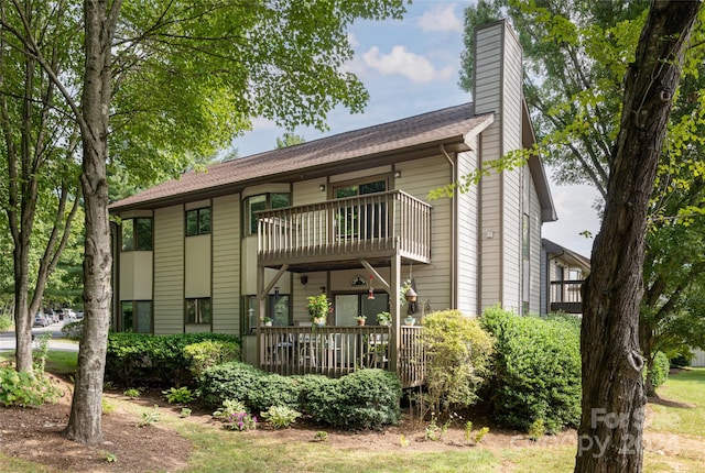 rear view of property with a balcony