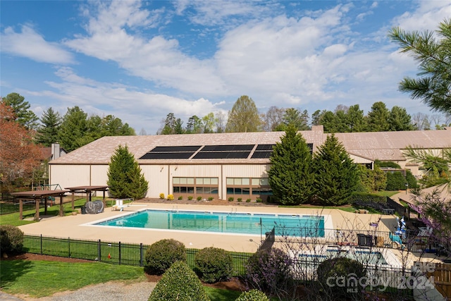 view of swimming pool with a yard and a patio