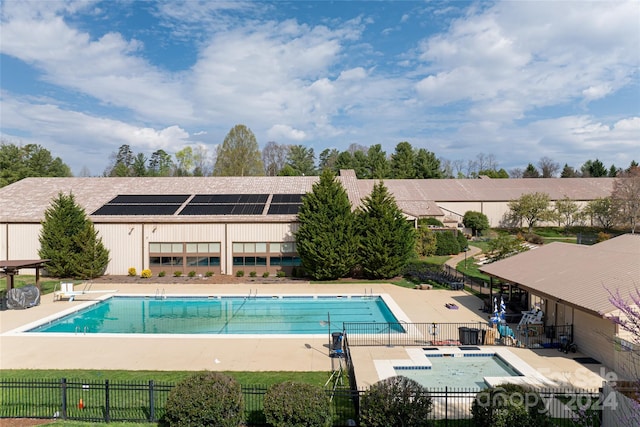 view of swimming pool with a jacuzzi and a patio