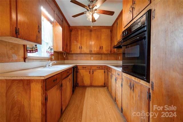 kitchen featuring black appliances, ceiling fan, light hardwood / wood-style floors, and sink