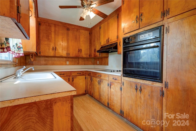 kitchen featuring black appliances, ceiling fan, sink, and light hardwood / wood-style floors