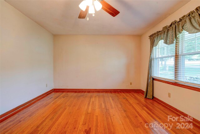 unfurnished room with ceiling fan and light hardwood / wood-style floors