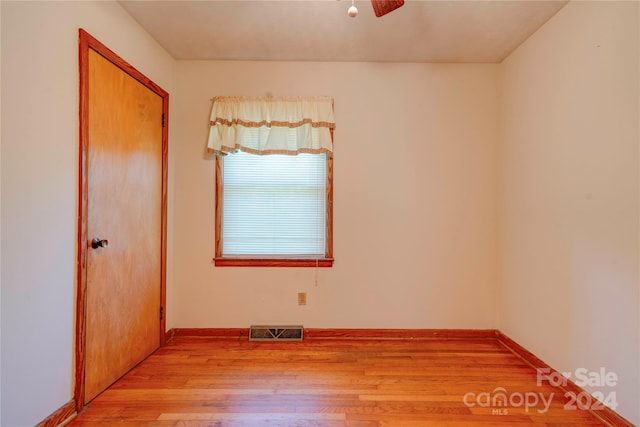 spare room featuring ceiling fan and light wood-type flooring