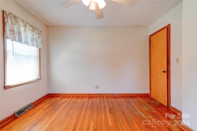 spare room featuring ceiling fan and wood-type flooring